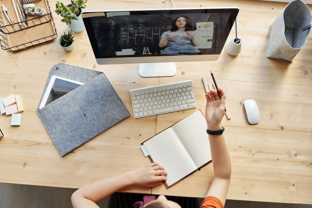 person at home desk doing virtual learning